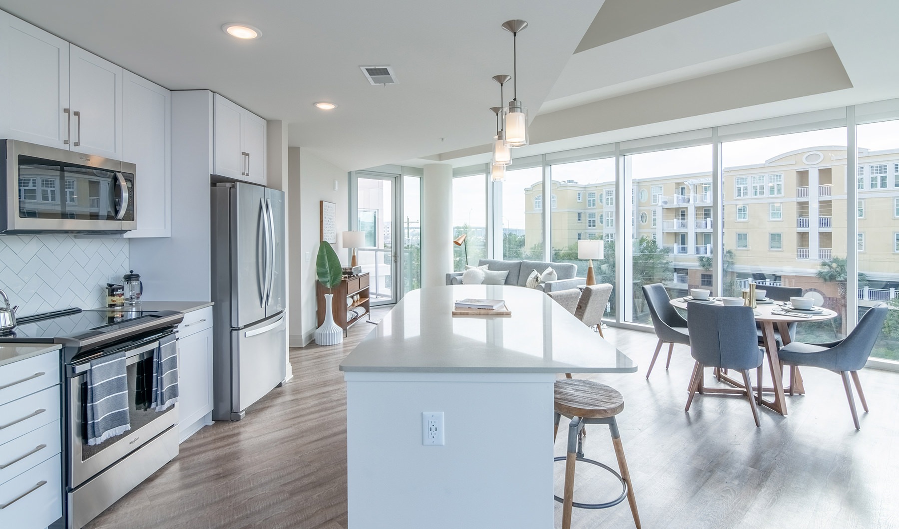 Kitchen  Spacious and well lit kitchen with wood floors and stainless steel appliances.